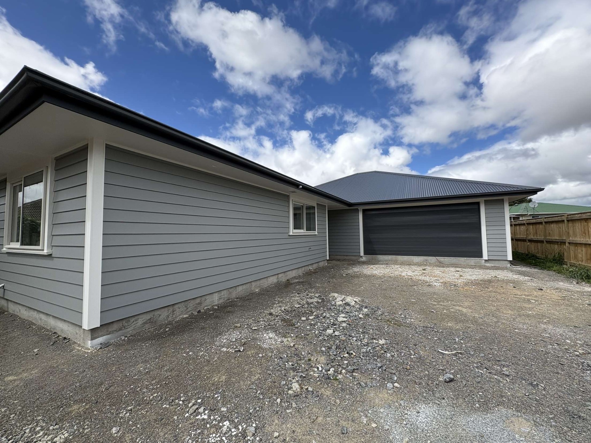 Newly painted grey weatherboard home with charcoal trim